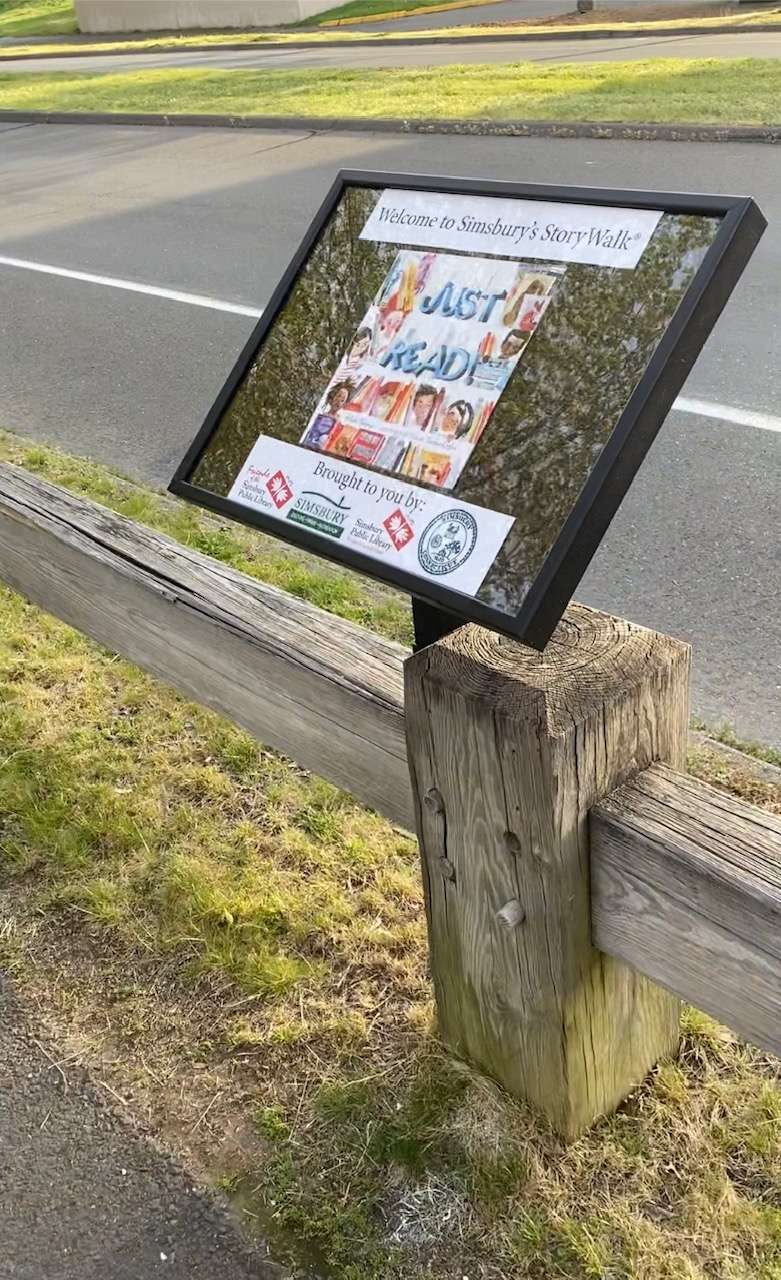 StoryWalk displays installed beside a sidewalk